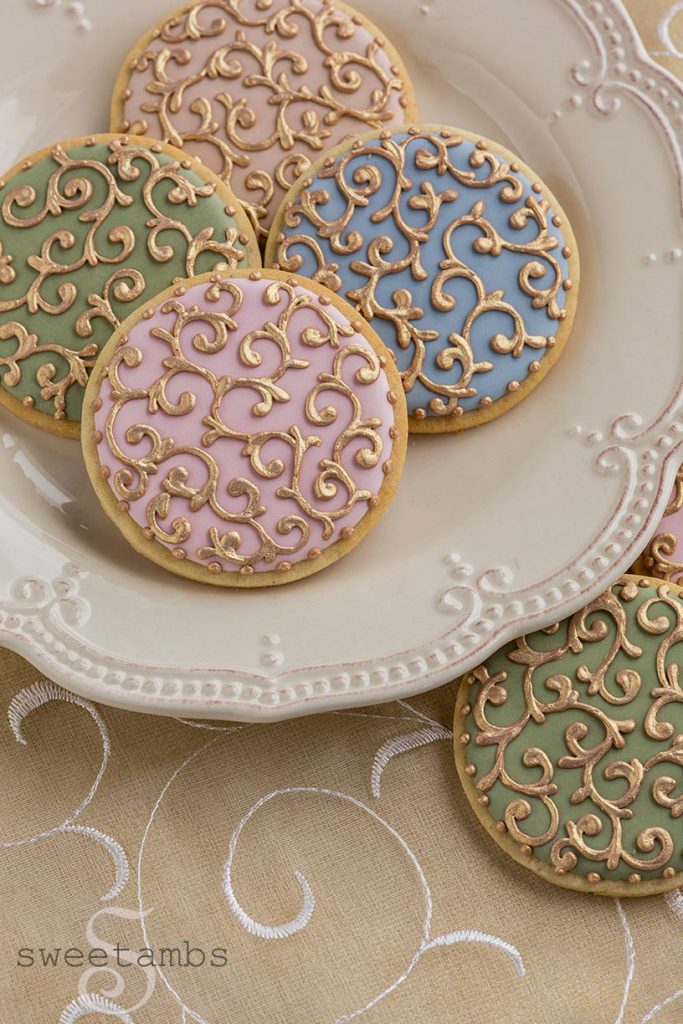 pastel cookies with gold royal icing filigree 