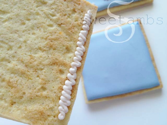 Icing applied to the bottom edge of one of the short sides of the rectangle piece.