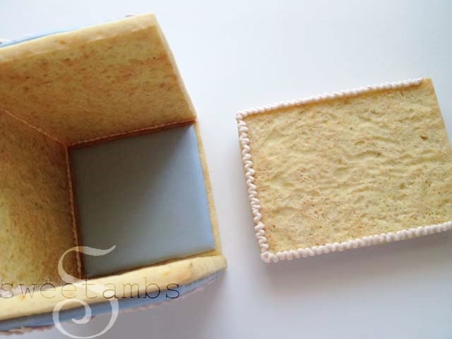 icing applied to both sides and the bottom of the last wall of the cookie box.
