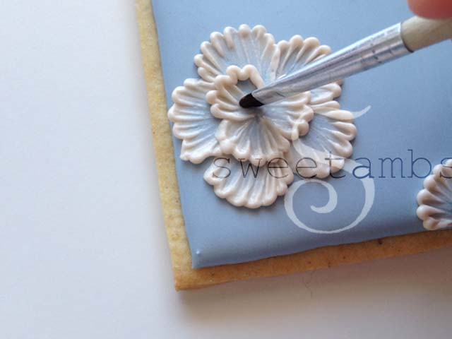 A partially completed flower being brushed to create the embroidered texture on the second layer of petals.