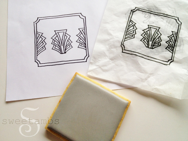 template, tissue paper with traced template, and a blank iced cookie in gray icing