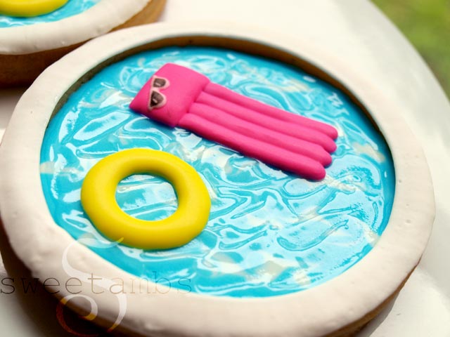 cookies decorated to look like swimming pools with pool floaties