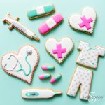 cookies for nurse appreciation decorated to look like a syringe, bandages, pills, a thermometer, and a stethoscope 