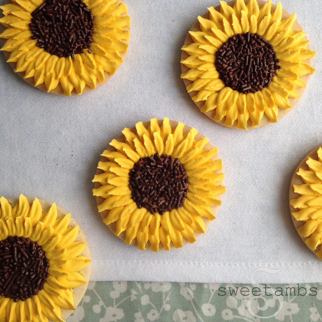 Cookies decorated with royal icing and chocolate sprinkles to look like sunflowers