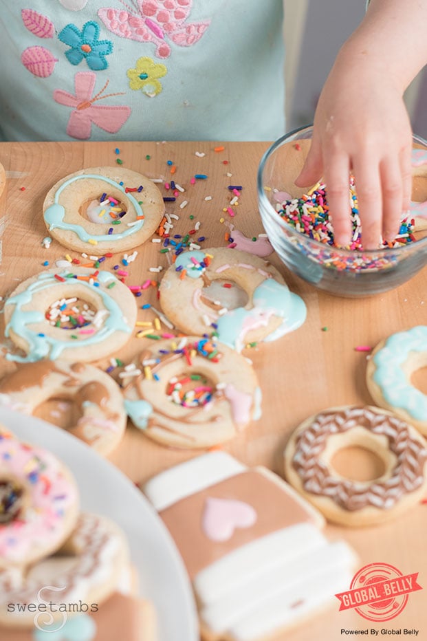 Toddler decorating cookies with sprinkles
