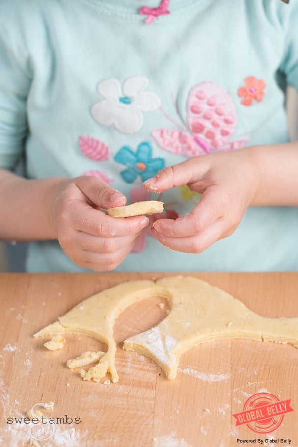 Toddler cutting cookie dough