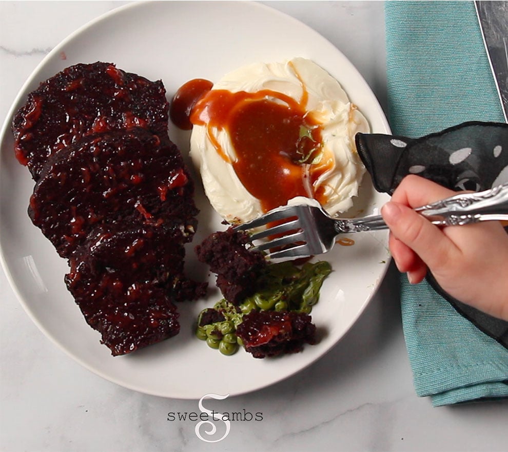 Chocolate cake, frosting, and caramel sauce that looks like a meatloaf dinner