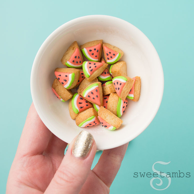 Small bowl filled with tiny watermelon slice cookies.