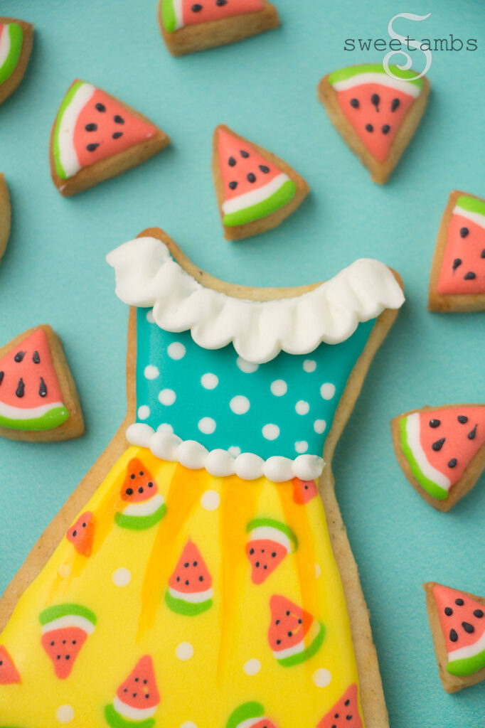 close up of watermelon dress cookie surrounded by tiny watermelon slice cookies