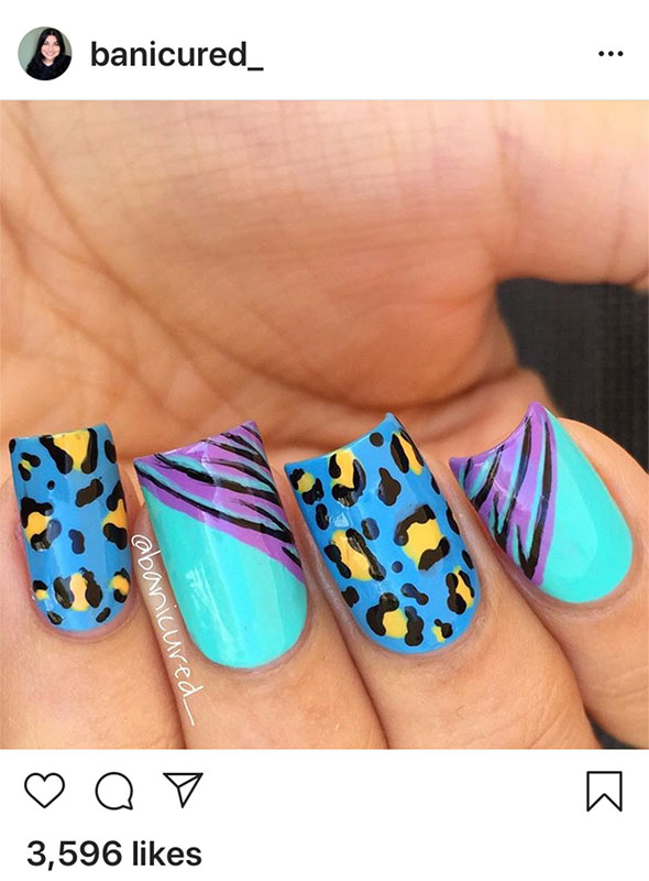 Nails painted with brightly colored animal prints.