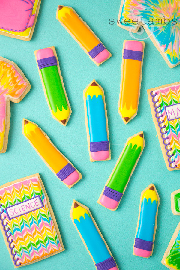 Back to school cookies. This set of cookies is decorated with brightly colored royal icing to look like tie dye t-shirts, pencils, spiral notebooks with the words Math and Science written on them.