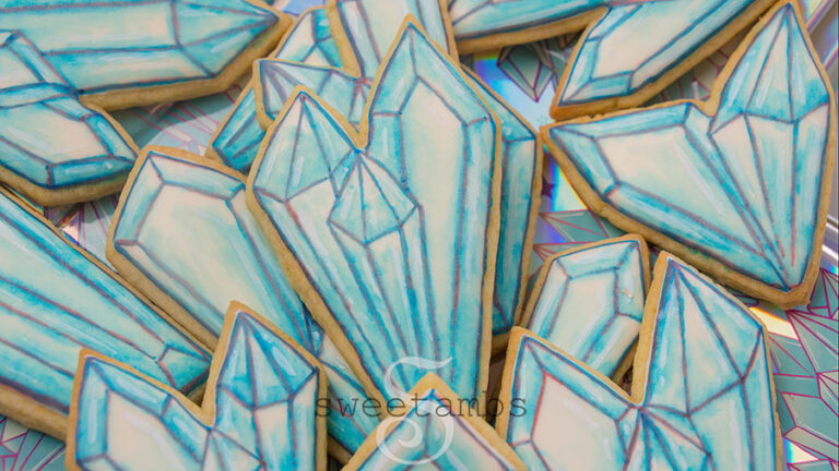 Watercolor crystal cookies - Cookies decorated with royal icing and watercolor technique to look like crystals. There are outlines on the cookies drawn with edible ink marker.