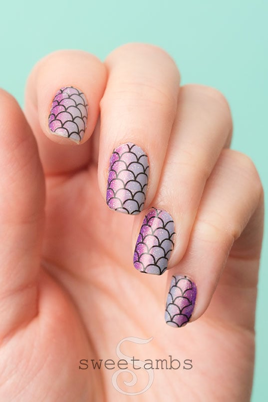fingernails decorated with shimmery purple and blue gradient with mermaid scales