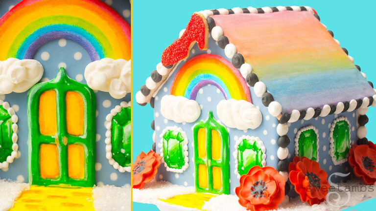 A collage of two images. The right side shows a gingerbread house decorated with brightly colored royal icing in a Wizard of Oz theme including rainbows, poppies, a ruby slipper, emeralds, and a yellow brick road. The left side of the image shows a close up of the green door with glowing yellow windows on the gingerbread house.