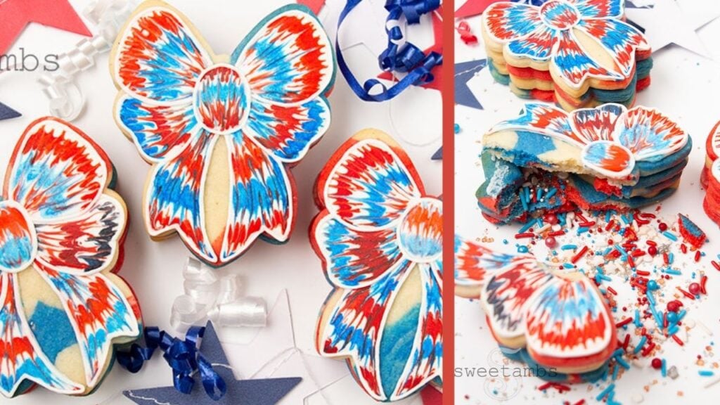 3 bow shaped cookies decorated with red, white, and blue royal icing with a tie dye effect. The cookies are surrounded by 4th of July decorations. The right side of the image shows one of the cookies broken open with red, white, and blue sprinkles spilling out.
