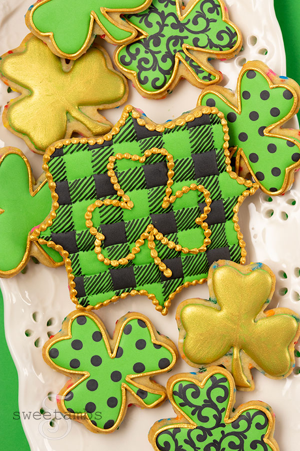cookies for saint Patrick's day decorated with green, black, and gold royal icing