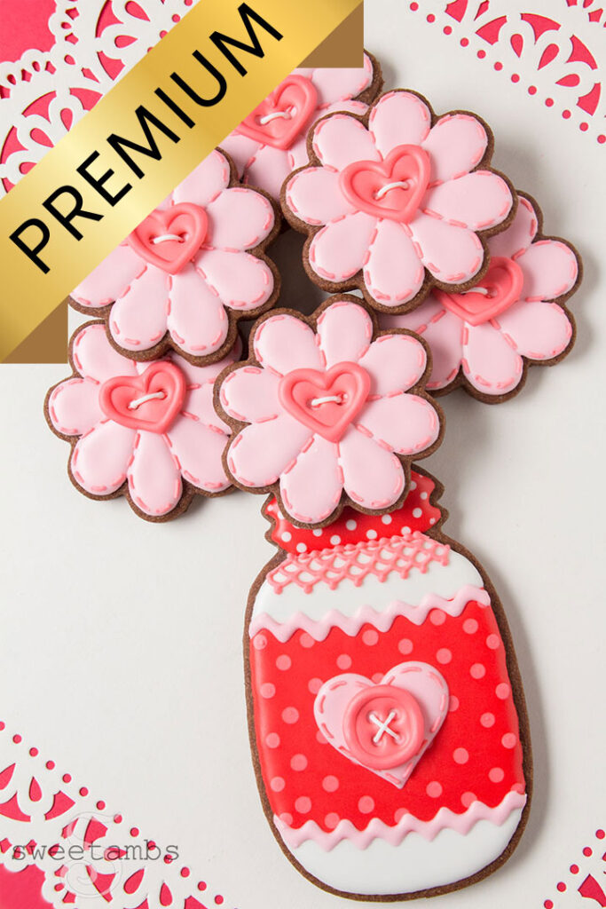 A cookie decorated to look like a mason jar holding a bouquet of cookie flowers. A banner with the word Premium is across the top left corner of the image