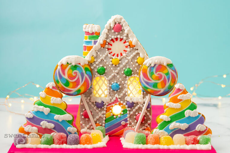 A scene made of gingerbread cookies and royal icing of a christmas cottage decorated with candy