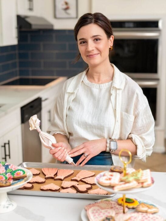 Amber Spiegel decorating cookies in her kitchen