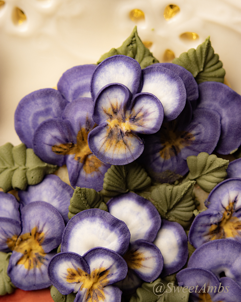 A close up of the potted violas cookies, showing the detail of the royal icing flowers.