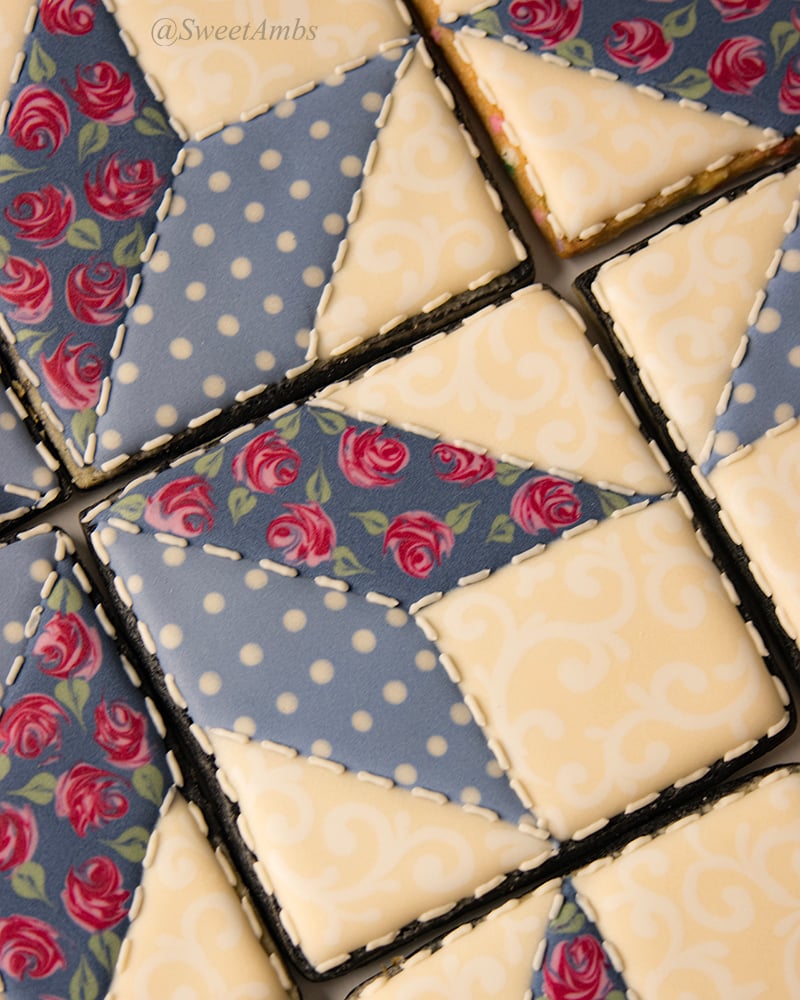 A close up of the star quilt cookies decorated with royal icing, showing the stitching detail around the patches.